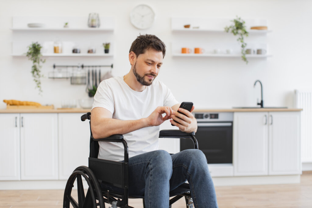 Man in a wheel chair with a mobile